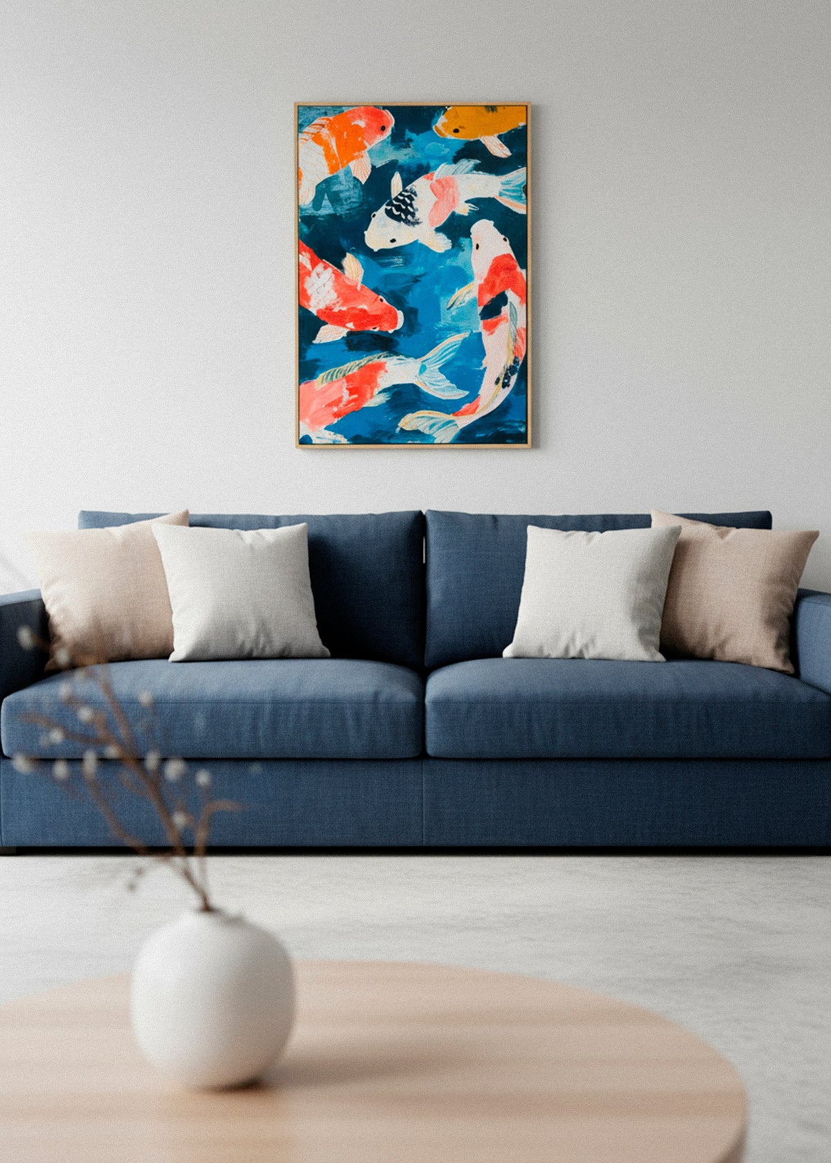 Koi fish canvas print hanging above blue sofa in a modern living room.