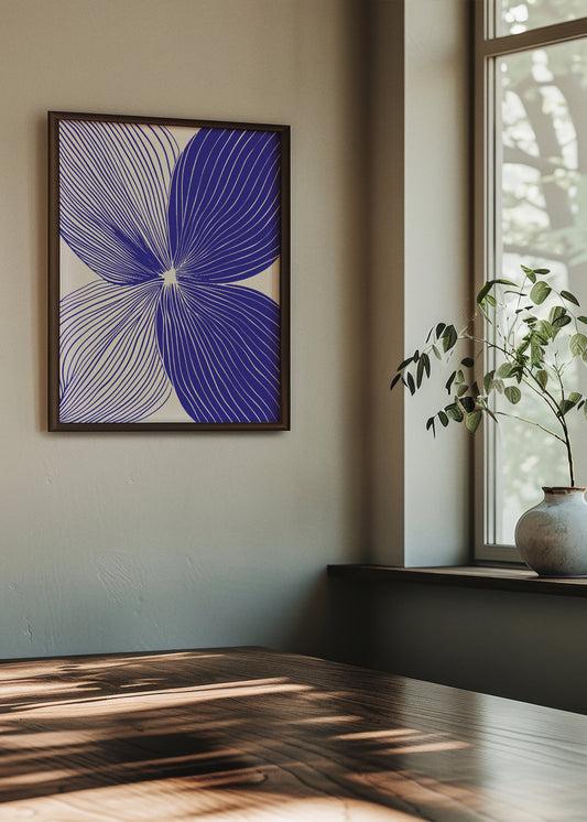 Graphic blue and white line art titled "Shape no. 20" featured in a modern interior with natural sunlight and greenery, adding an artistic contrast to the neutral walls.