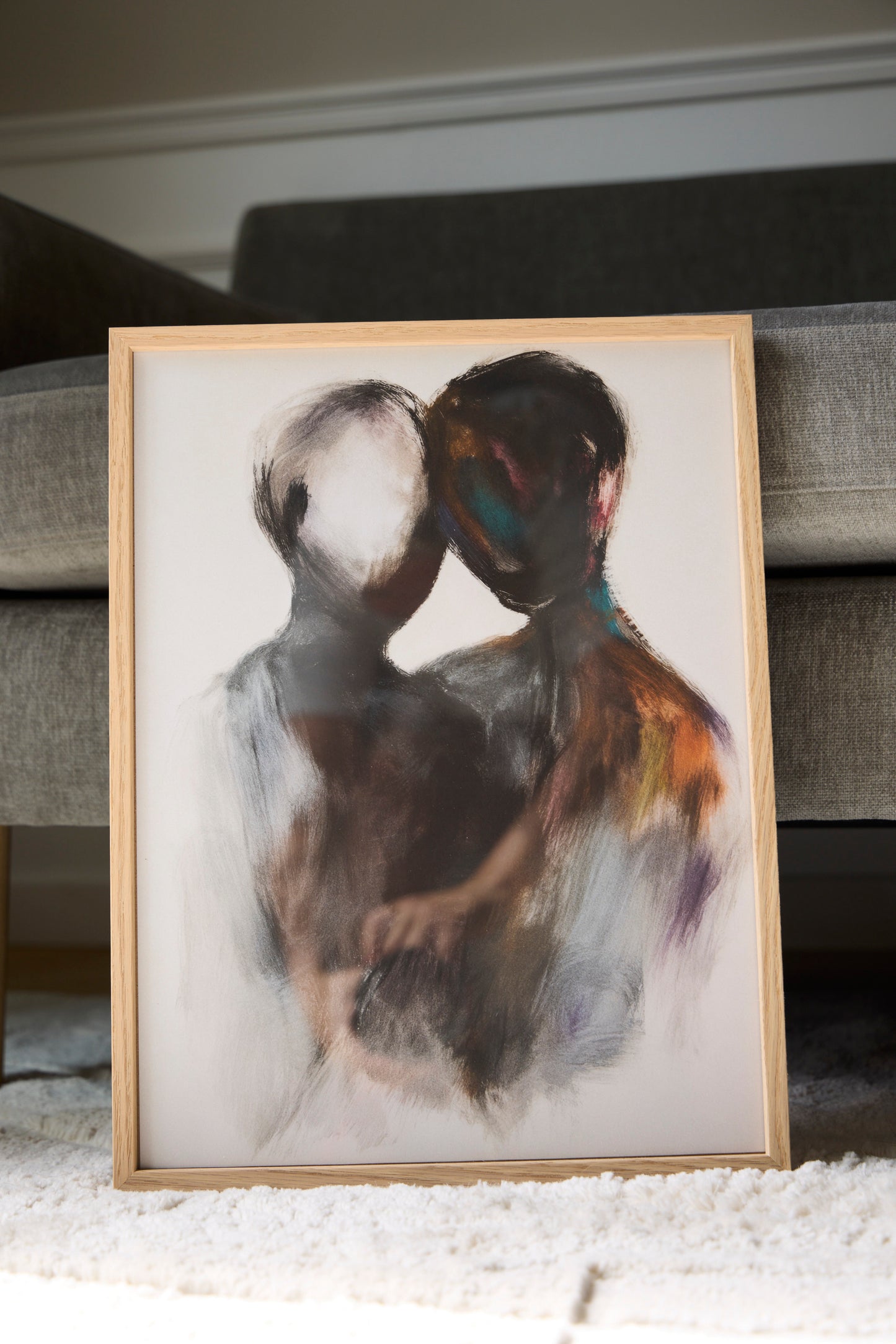 Pesona abstract figurative poster featuring two embracing figures, styled in an oak frame in a modern Scandinavian interior.