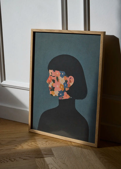 A Face I Once Knew floral portrait wall art in an oak frame, styled in natural sunlight with a dark female silhouette and colourful flowers.