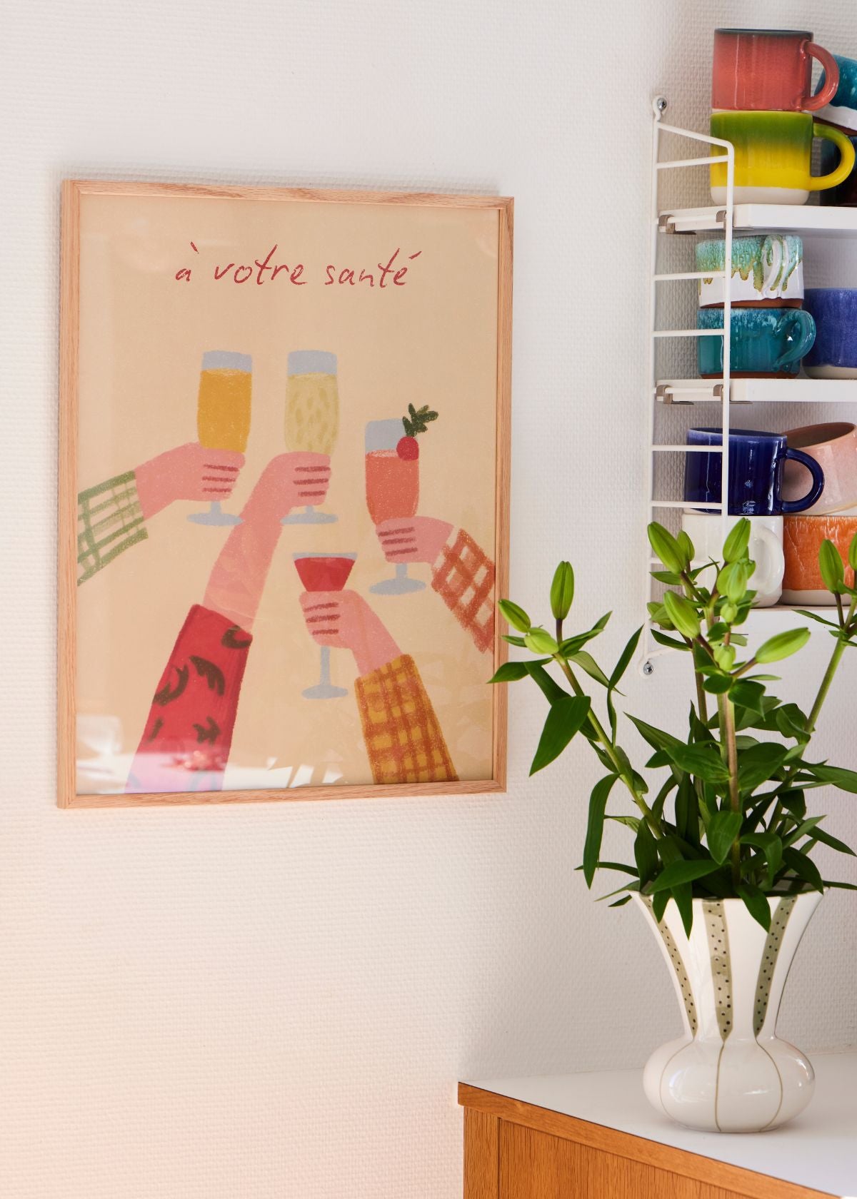 Colorful kitchen poster with hands raising glasses and text ‘à votre santé’, framed in oak, perfect for dining room or bar decor.