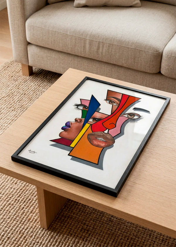 Abstract Geometric Faces by Manasseh Johnson Sr. art print featuring layered faces, eyes and lips combined with bold geometric shapes in red, blue, yellow, green and orange, displayed in a black frame on a wooden coffee table in a Scandinavian living room.