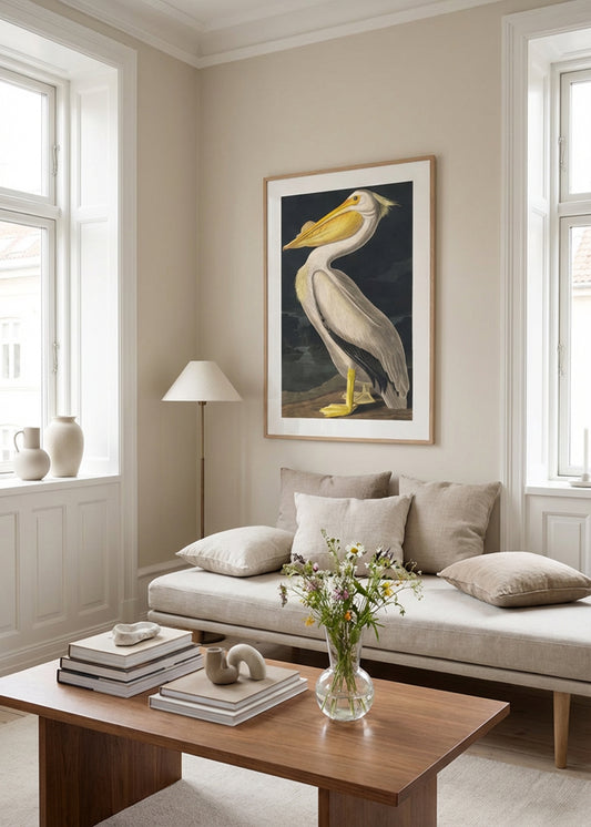 XL pelican art poster in oak frame styled above beige sofa in elegant Scandinavian living room with natural light and neutral tones.
