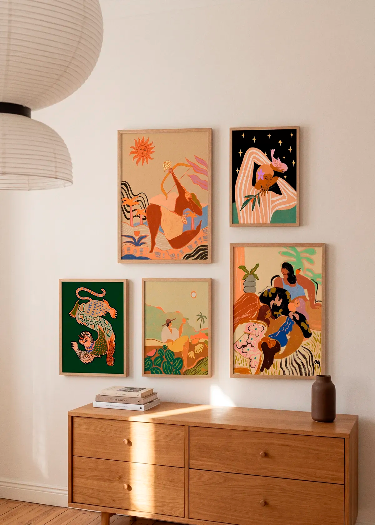 Asian Tiger Green by Arty Guava shown as part of a curated gallery wall with five Arty Guava posters in warm, colourful tones above a wooden dresser in a Scandinavian interi