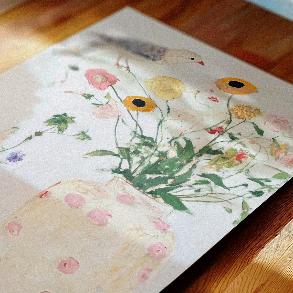 Pastel green bird artwork ‘Bird No. 1’ displayed flat on a wooden table with sunlit shadows creating a serene, natural setting.