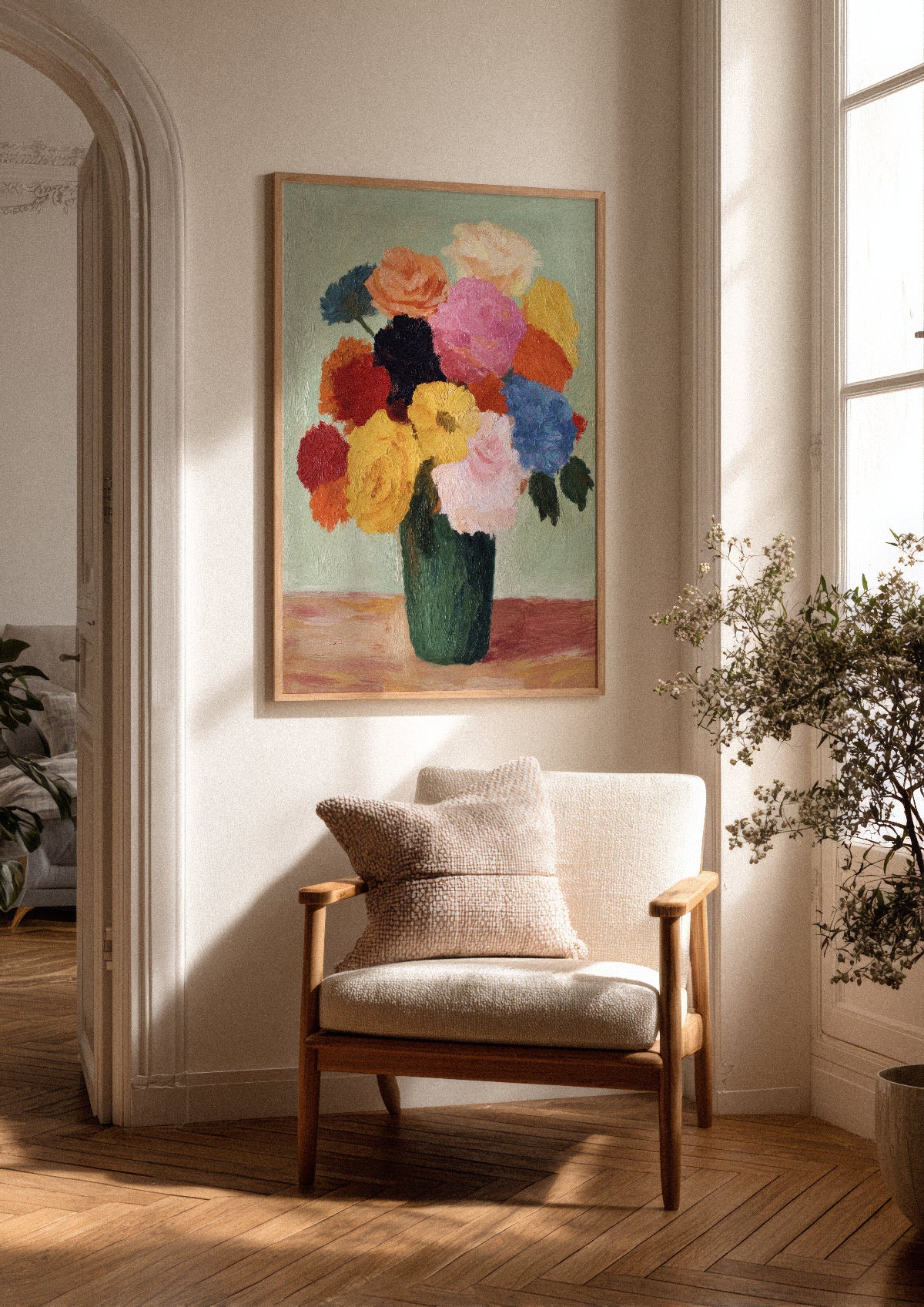 Blossoms poster in an oak frame hanging in a bright Scandinavian living room, with natural sunlight, wooden flooring, a cozy armchair, and soft neutral decor.