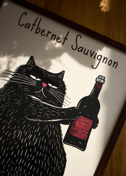 The Catbernet Sauvignon poster featuring a black cat and a wine bottle, shown in warm shadows on a wooden floor.