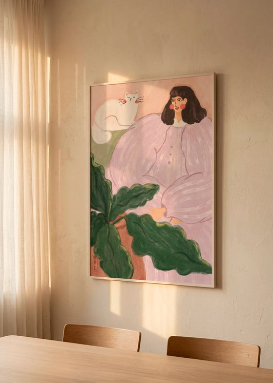 Cozy Woman With Cat art poster by Dirkie Nell displayed in a warm, softly lit interior with natural wood tones and gentle sunlight.