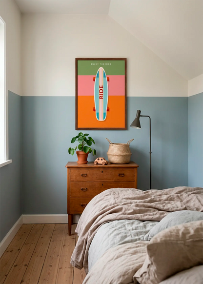 Enjoy The Ride Skateboard art poster by Dominique Vari displayed in a relaxed bedroom with blue-grey walls, natural wood furniture, soft neutral bedding and warm daylight.