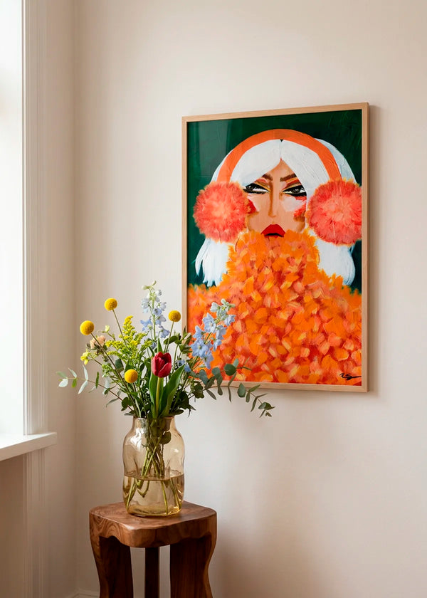 Glamorous Orange Earmuffs by Amy Straley – framed portrait art poster featuring a woman with white hair, vivid orange earmuffs and a textured orange top, styled in a bright warm interior with natural wood and flowers.