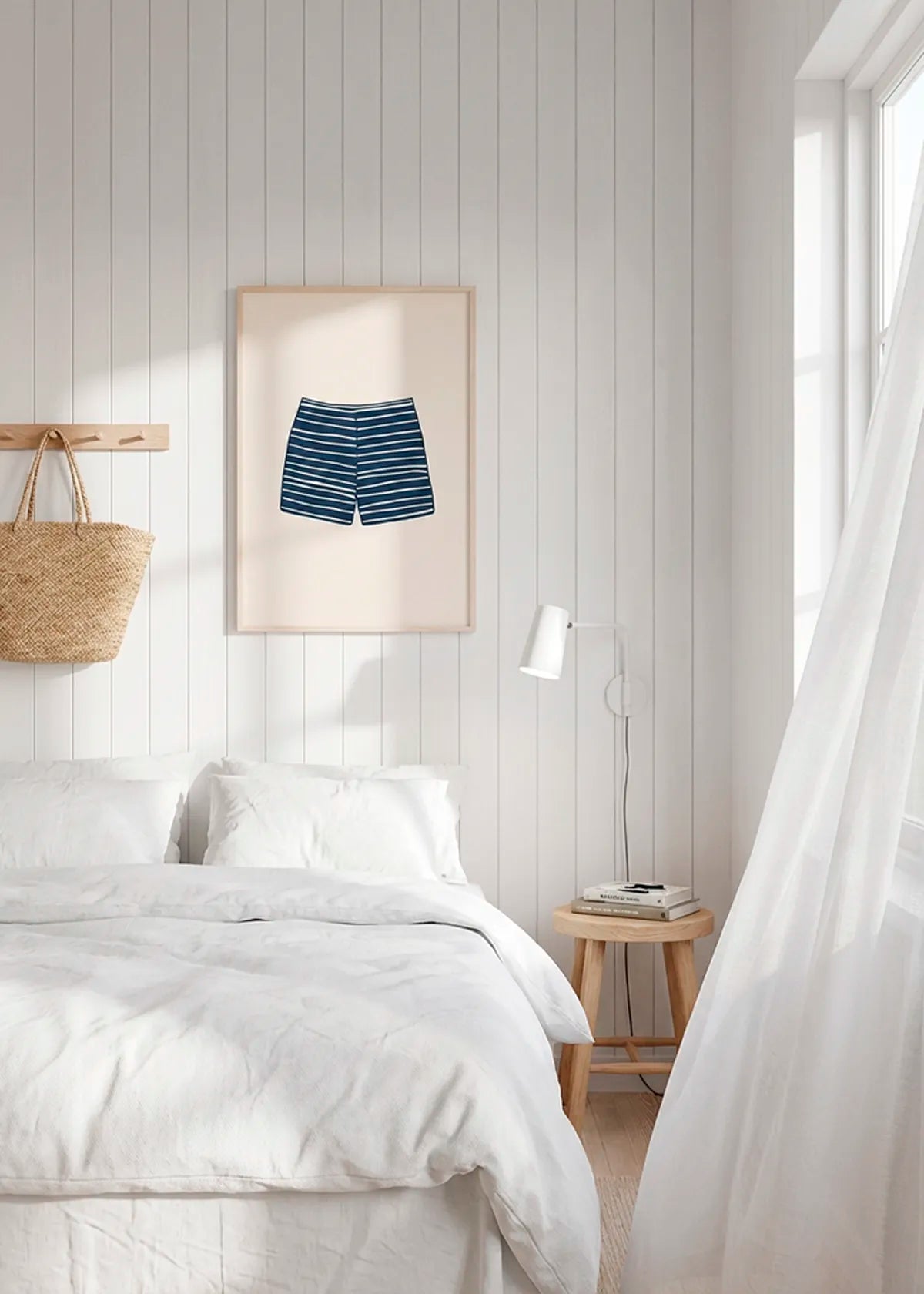 Striped swim shorts poster in oak frame styled above bed in bright Scandinavian bedroom, calm summer house interior decor