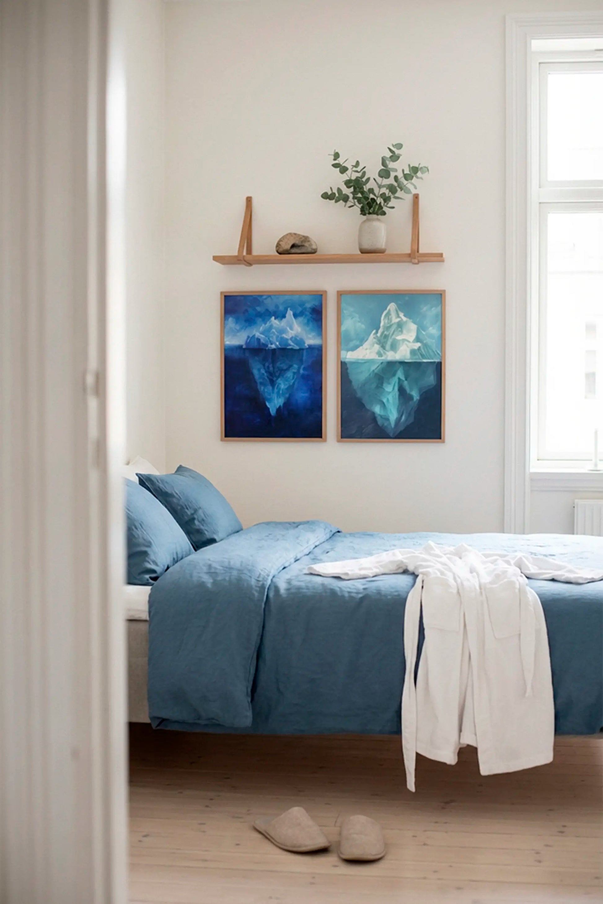 Bedroom interior with blue Iceberg Night posters creating a calm and relaxing atmosphere above the bed