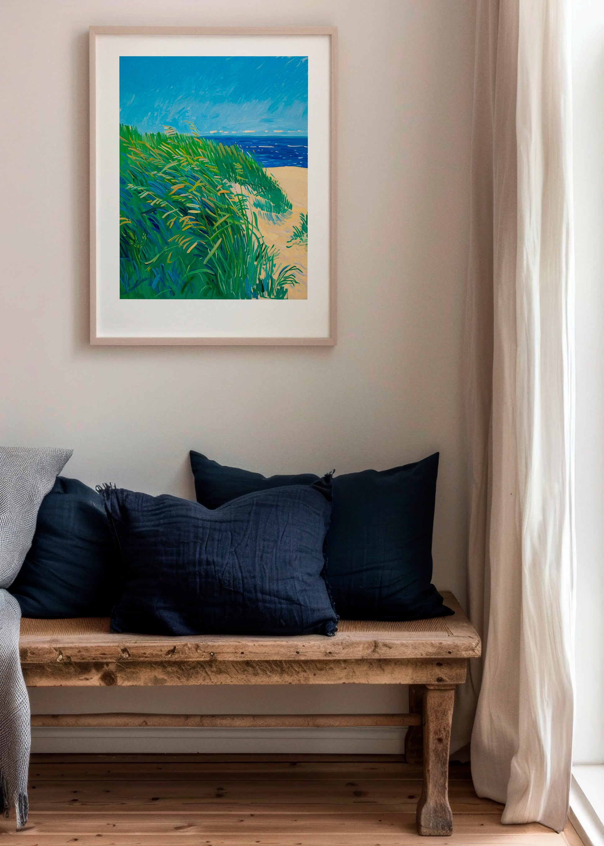 Lime Grass poster in a Scandinavian living room with natural wood bench and soft neutral tones, featuring vibrant green grass, sandy beige and deep blue ocean colors