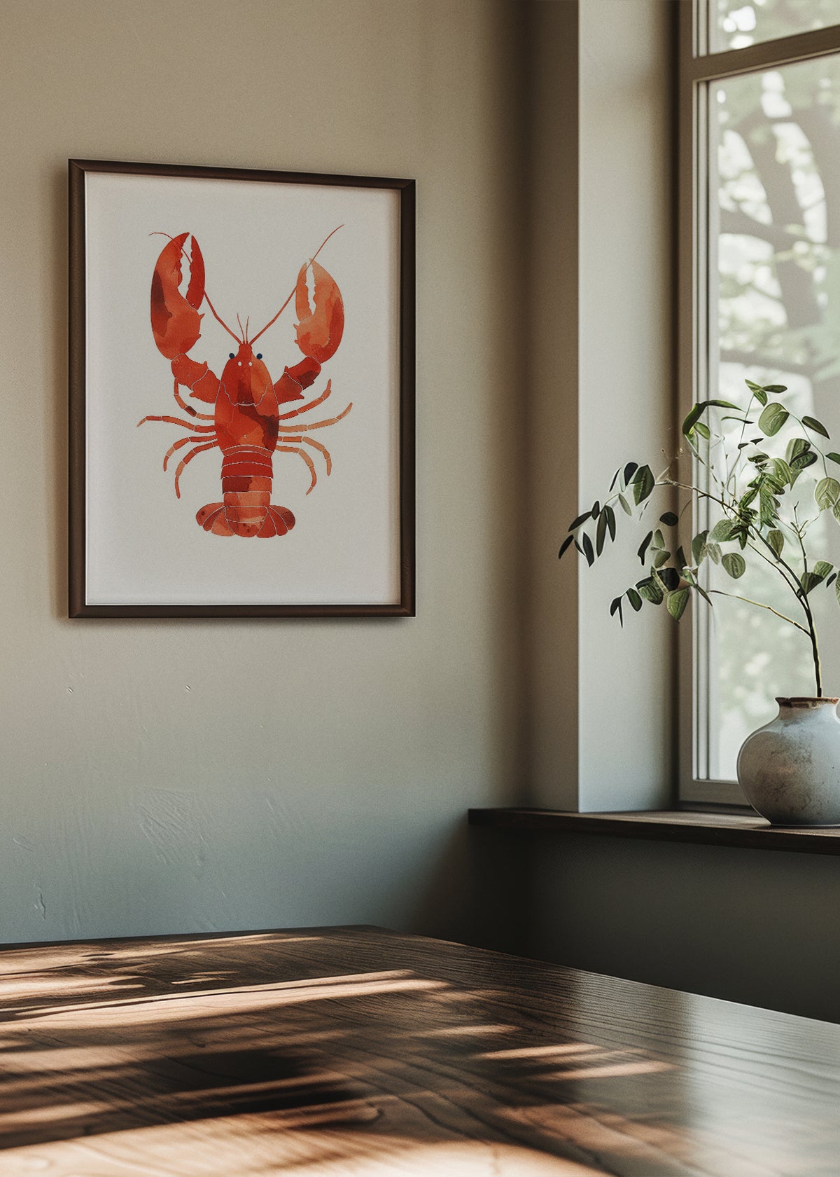 ibrant red lobster watercolor print titled "Lobster Watercolor" displayed in a dark wooden frame in a stylish dining area with natural light and minimalist decor.