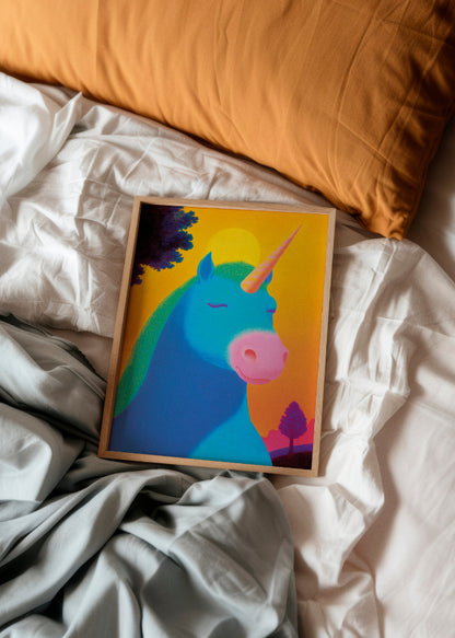 Colorful unicorn poster in wooden frame placed on a white bed with soft pillows and sheets – a dreamy and playful bedroom decor setting.
