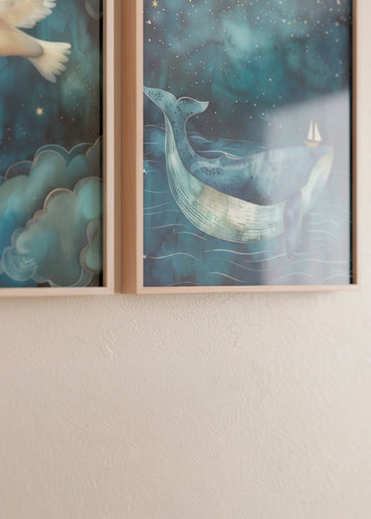 Close-up of the One Big Friend whale poster hanging beside the One Small Friend dove poster, showing detailed textures, blue tones and natural wooden frames on a light wall.
