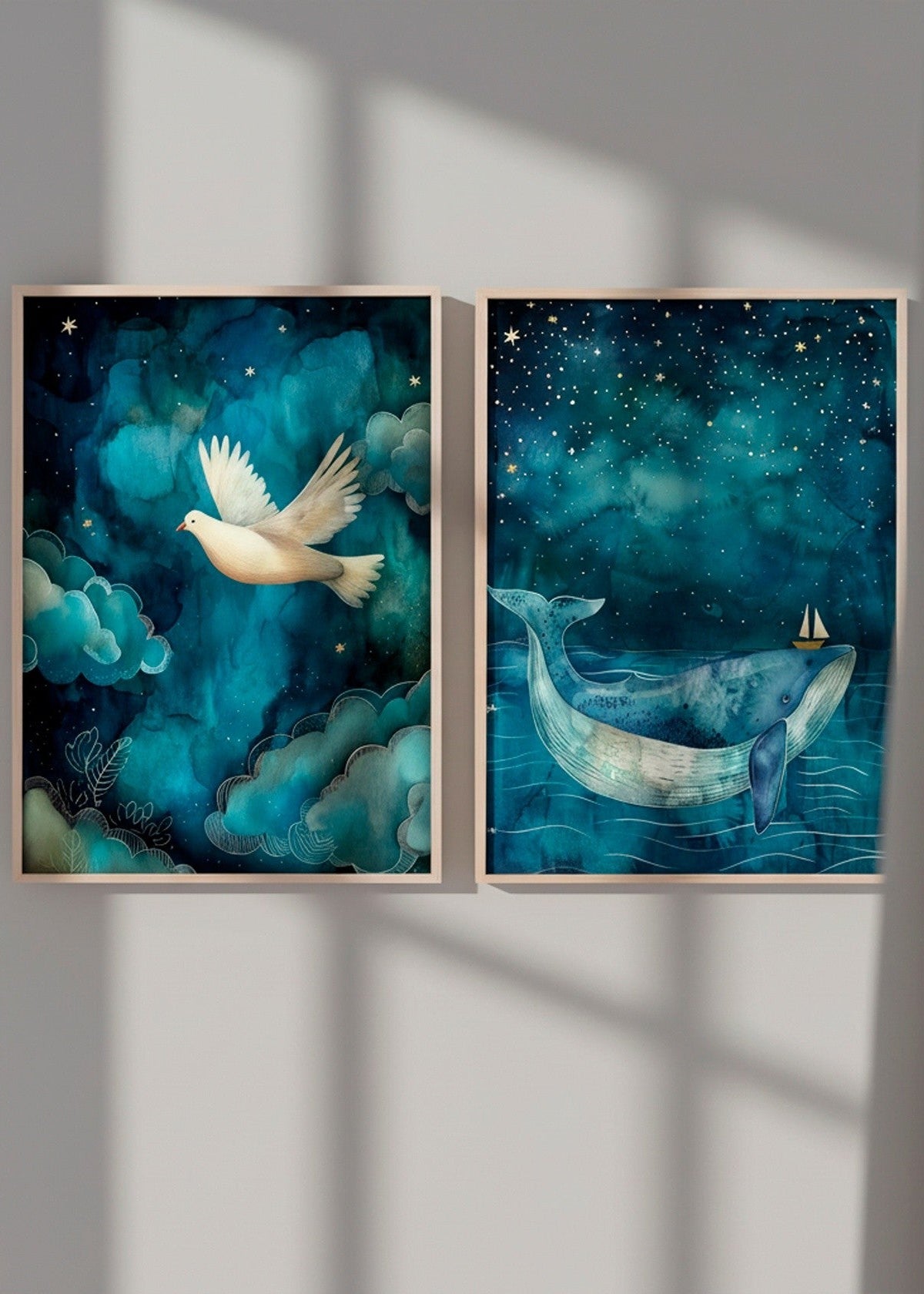 Nordic gallery wall featuring the One Big Friend whale poster and One Small Friend dove poster, illuminated by soft daylight with shadows cast across the artwork.