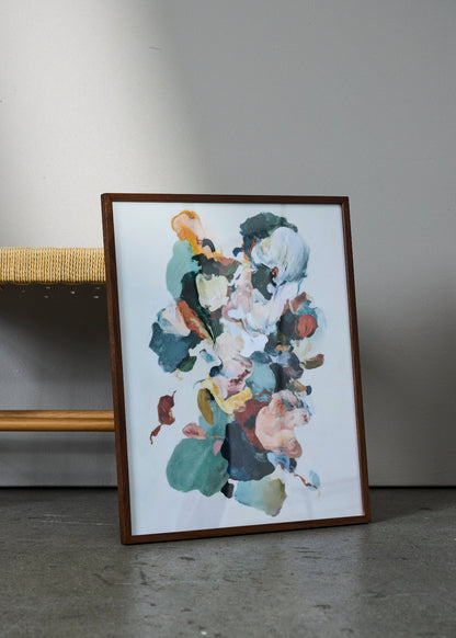 Petale poster from HelloPoster in dark wooden frame, featuring colorful abstract floral-inspired artwork, styled against grey wall with woven chair.