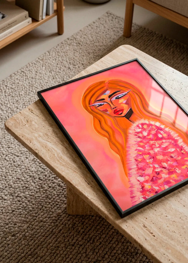 Pink Fur Glamour by Amy Straley – framed expressive portrait poster featuring a woman with long orange hair and a textured pink fur top, styled on a light stone table in a warm neutral interior.