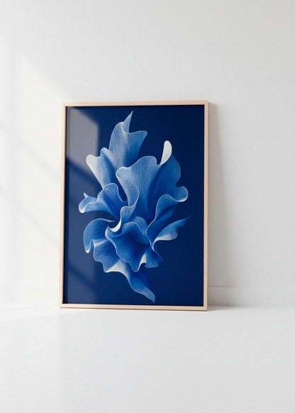 Shape No. 80 art print in an oak frame leaning against a bright white wall with soft natural light creating subtle window reflections.