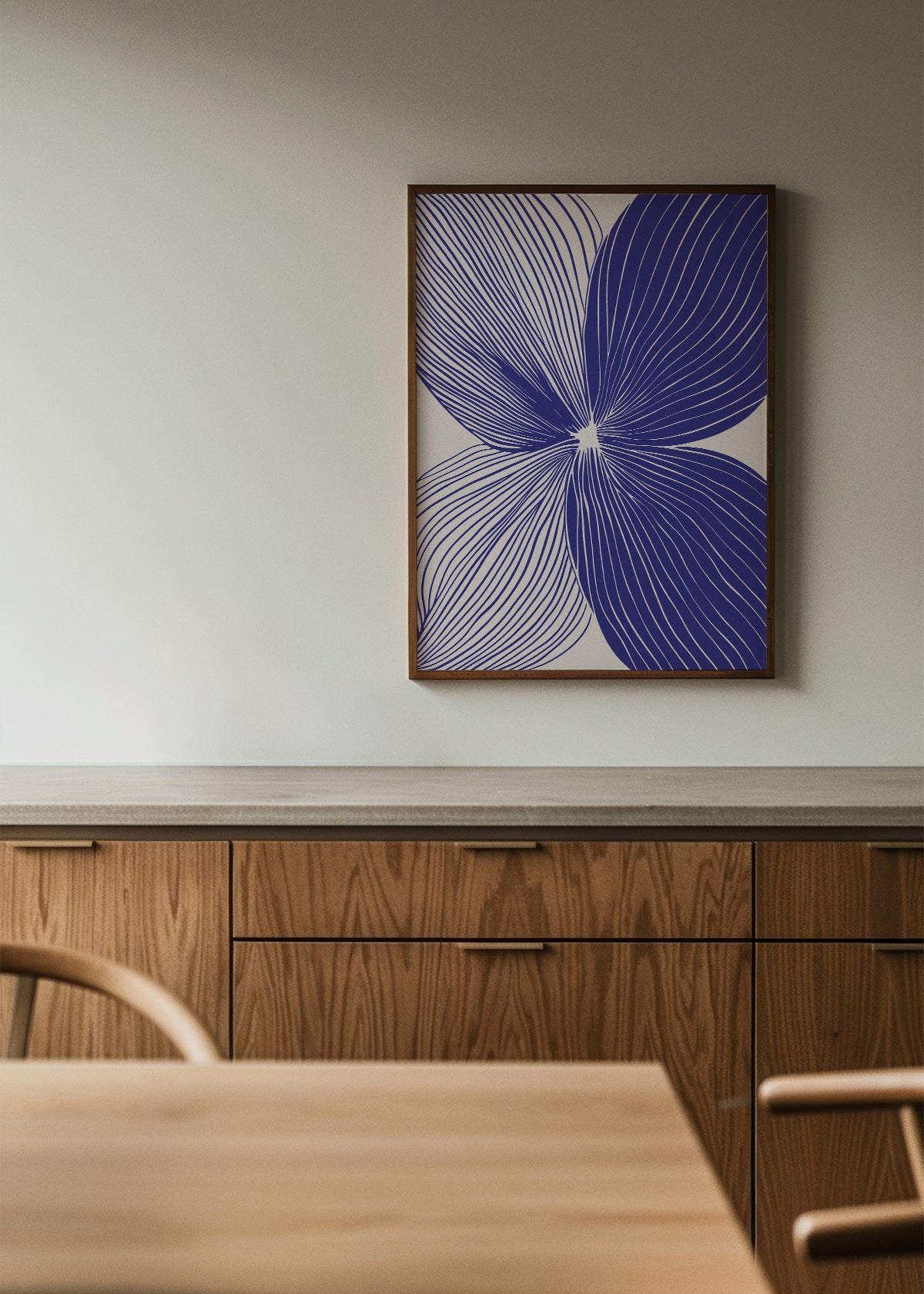 Modern abstract line art print titled "Shape no. 20" in a dark wood frame, hung in a contemporary kitchen with oak cabinets and clean lines.