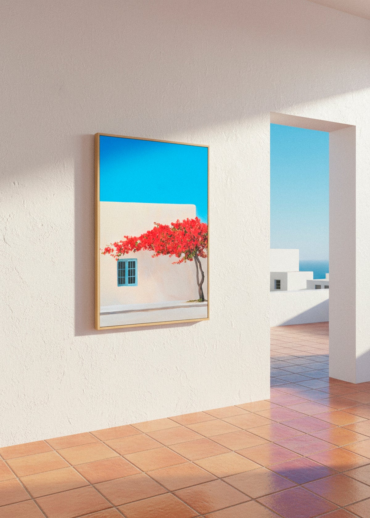 Framed “Siesta” canvas print hanging beside a wicker chair and olive branches in a sunlit patio setting.