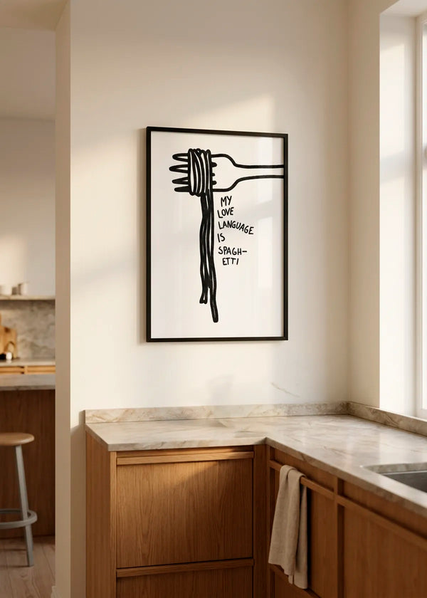 Spaghetti Love Language by Athene Fritsch – framed black and white kitchen poster featuring a fork with spaghetti and the words My Love Language Is Spaghetti, styled in a warm modern kitchen with natural wood cabinetry.