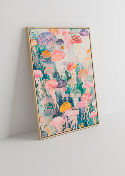 Framed canvas print featuring vibrant jellyfish leaning against a white wall with soft shadows.