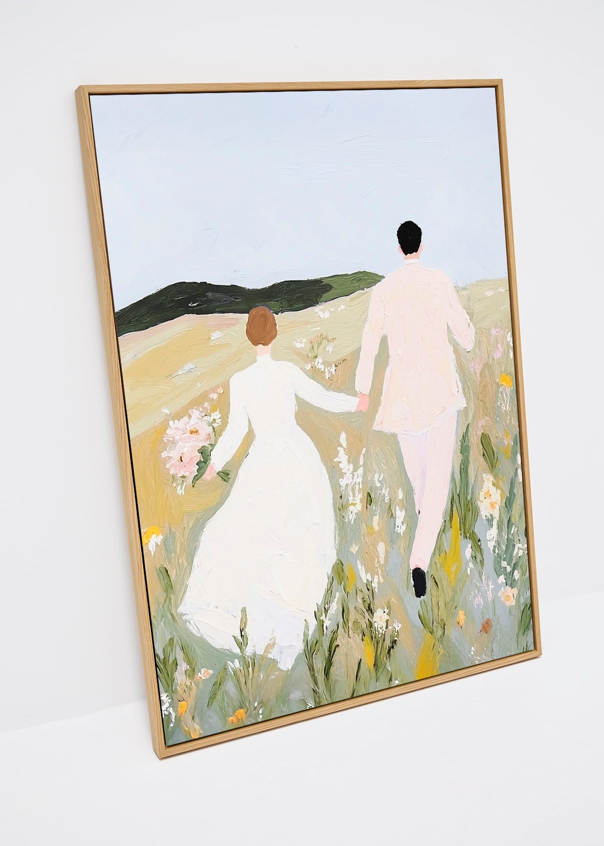 Canvas print of a couple in light clothing walking hand in hand through a sunlit meadow, with soft floral tones and a romantic mood.