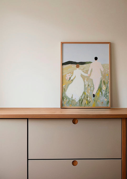 Us poster on a wooden sideboard – A romantic and dreamy art print depicting a couple in a field, adding warmth and elegance to a soft, neutral-toned interior.