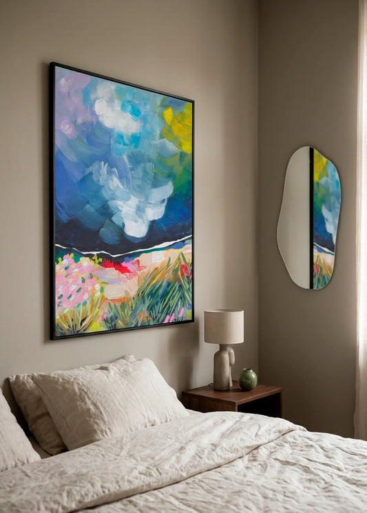 Vibrant Abstract Field Sky by Dirkie Nell – large framed abstract landscape poster with expressive blue sky, white clouds and colourful meadow, styled above a bed in a calm modern bedroom.