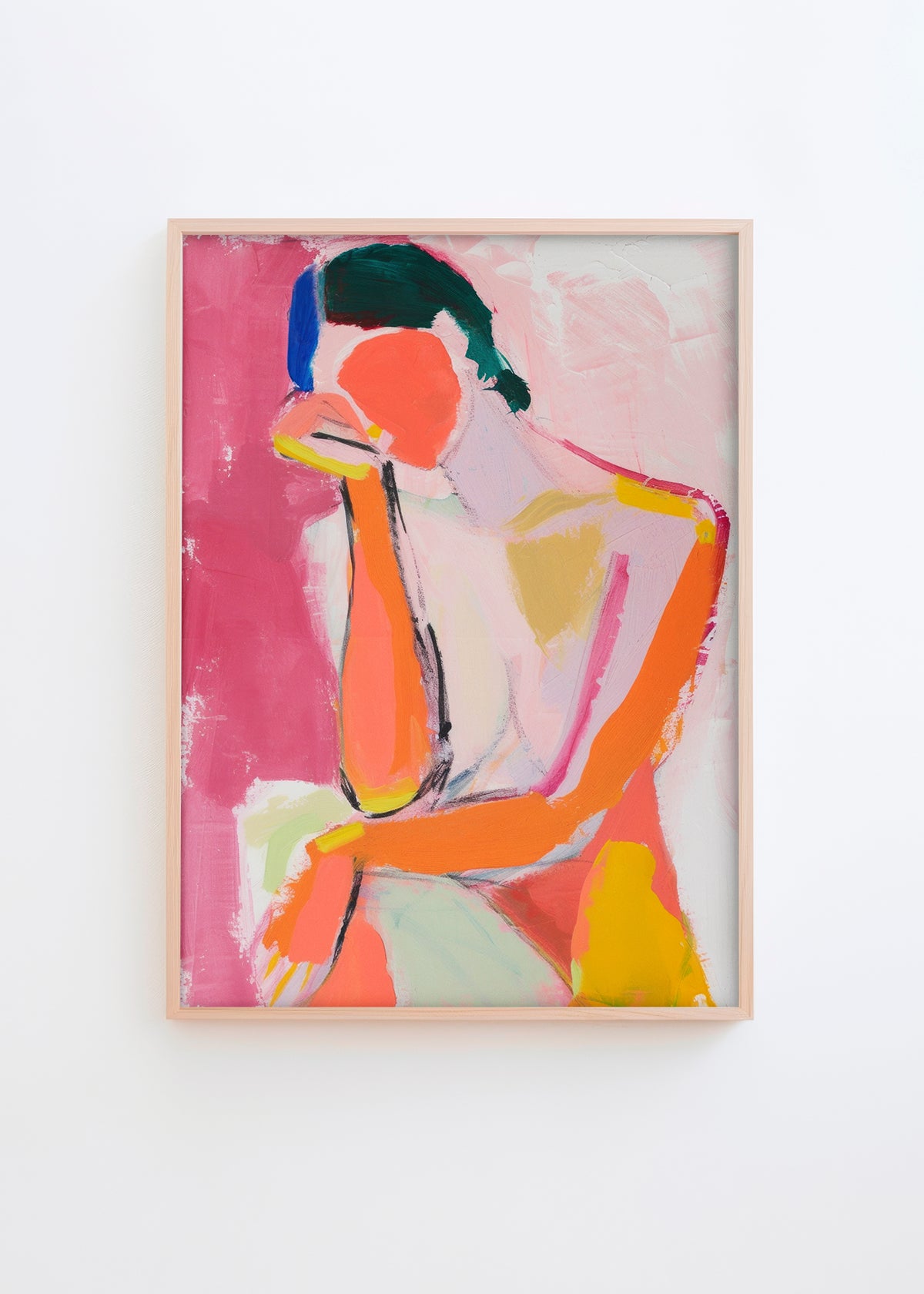 A vibrant abstract portrait poster, "Feminine," featuring bold pink, orange, and yellow brushstrokes with textured details, displayed in a natural wood frame.