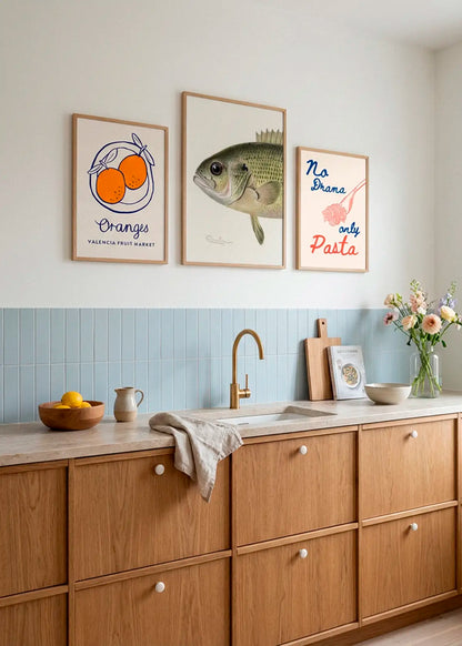 Oranges, Rock Bass and No Drama Only Pasta posters styled as a playful gallery wall in a Scandinavian kitchen
